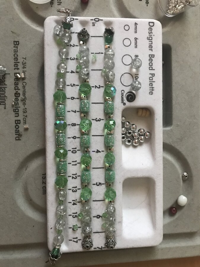 A bracelet laid out bead by bead on the design board