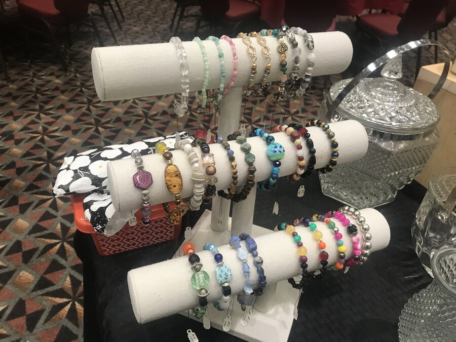 The bracelets set up on display stands at a market table